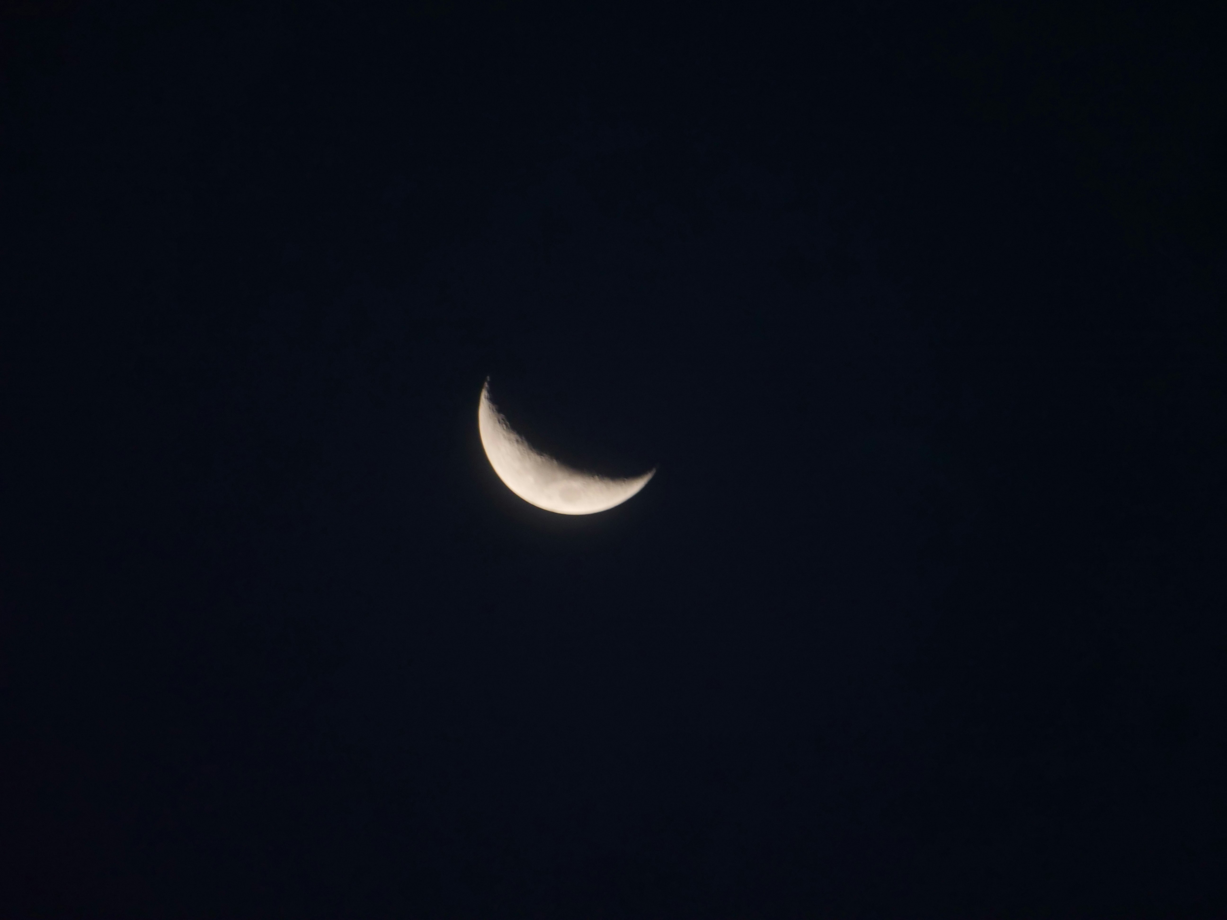 white crescent moon in dark night sky